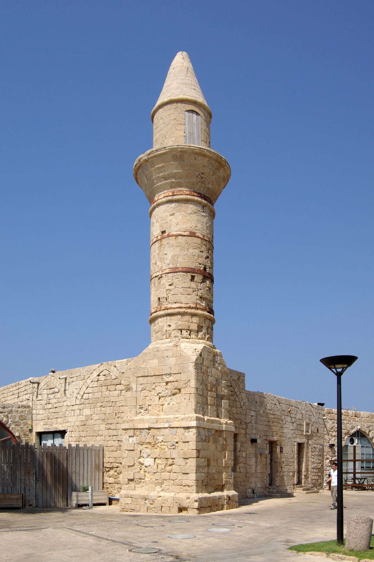 The arches of the high-level Roman aqueduct at Caesarea standing on the sandy Mediterranean beach