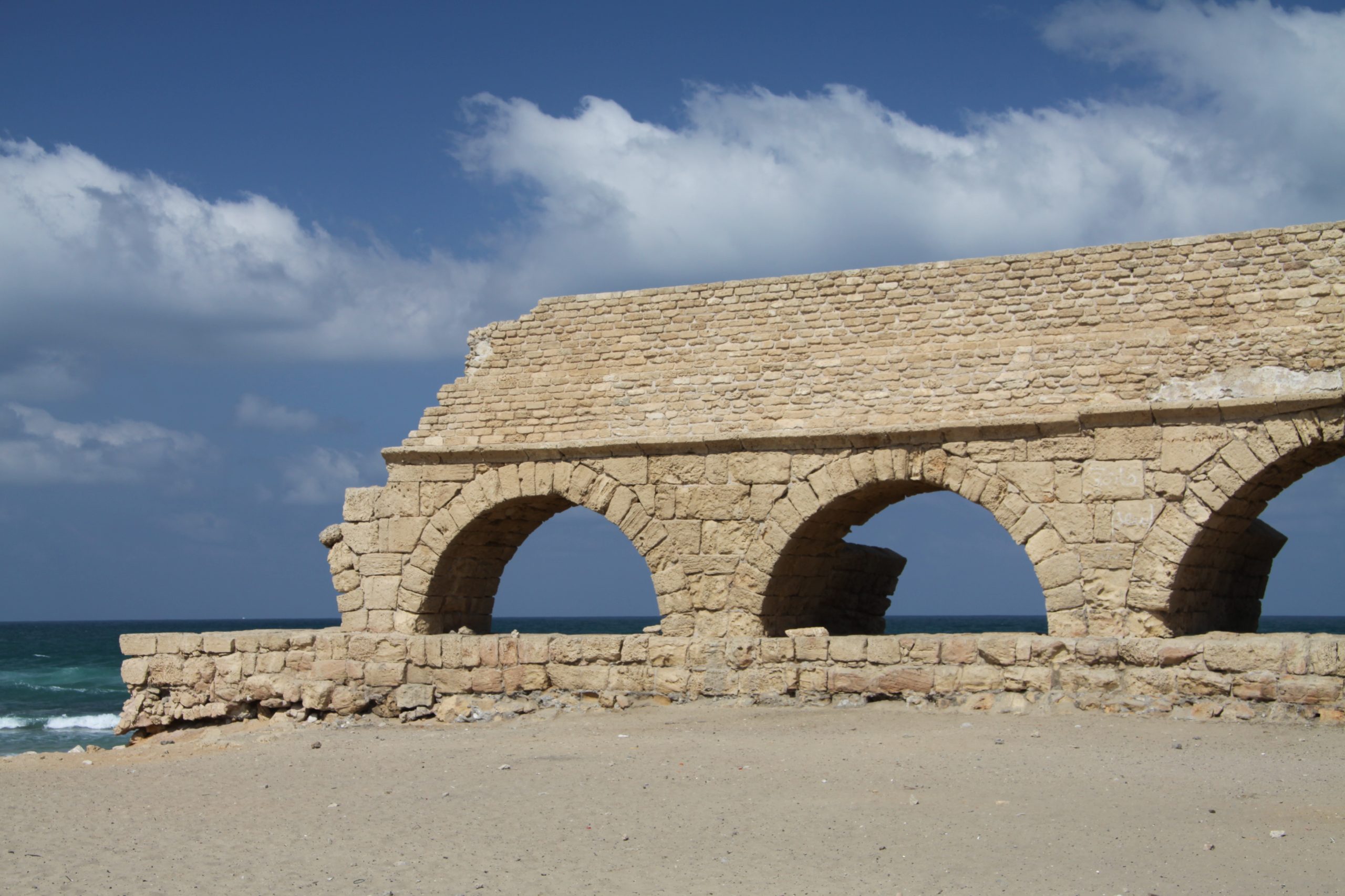 Caesarea, Israel: The Complete Visitor Guide 1 The ancient Roman aqueduct of Caesarea Maritima running along the Mediterranean beach in Israel