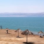 People floating effortlessly in the mineral-rich water at a Dead Sea beach in Israel