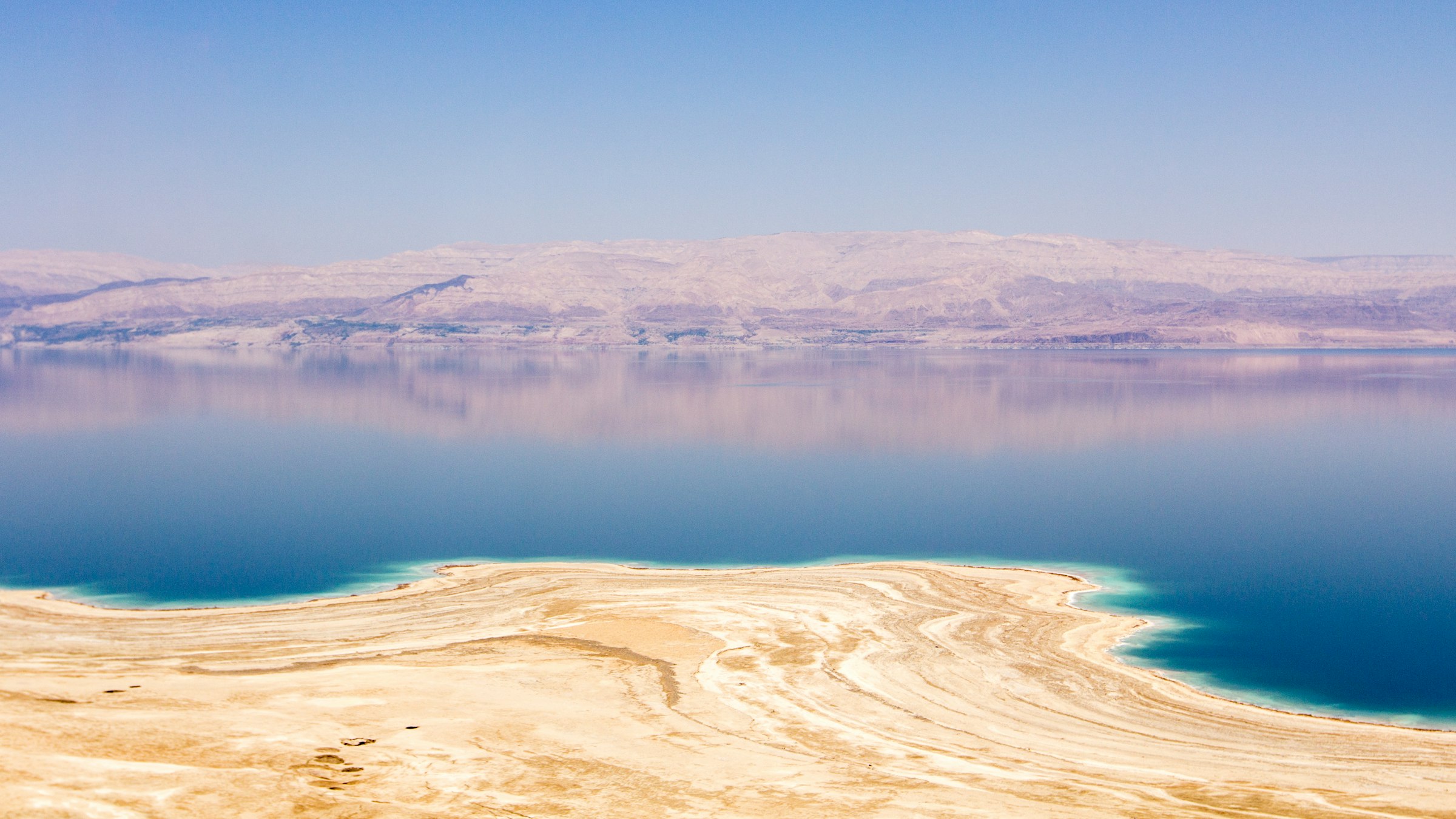 The turquoise water and mineral shore of the Dead Sea on a day trip in Israel