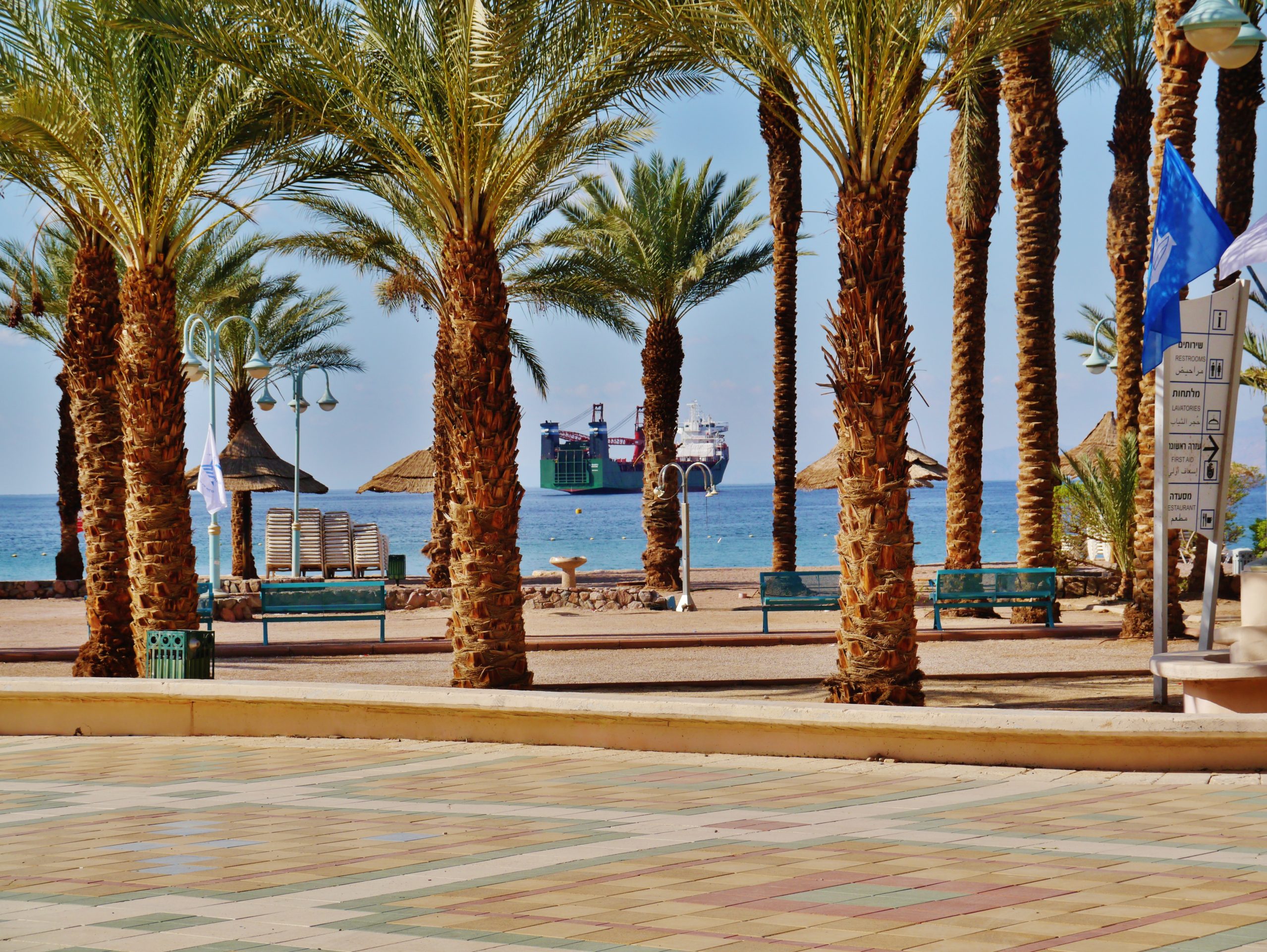 Things to do in Eilat: the Red Sea promenade and beach with the mountains of Jordan across the gulf