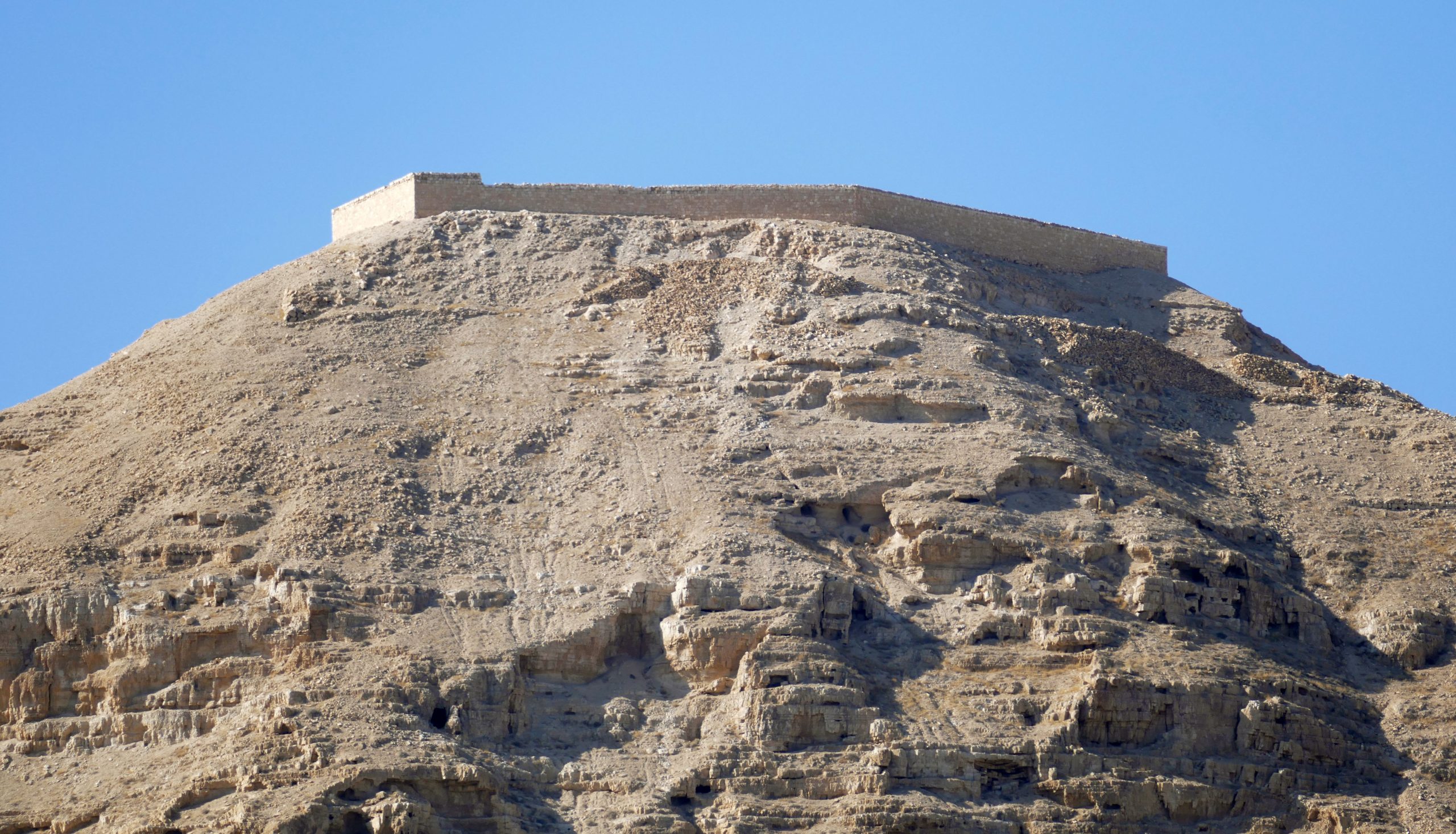 The excavated archaeological mound of Tell es-Sultan, ancient Jericho, with the Mount of Temptation behind