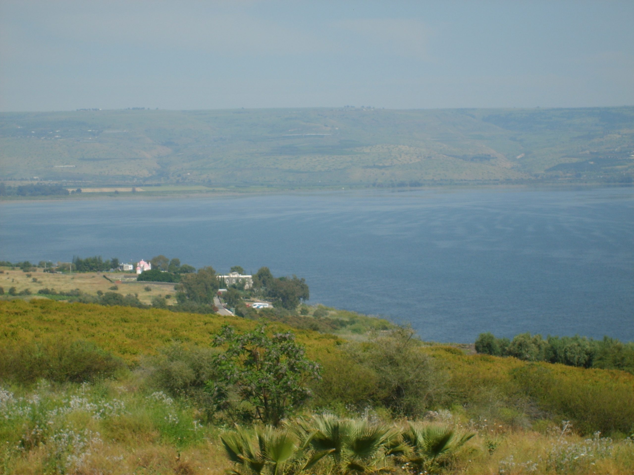 The green hillside of the Mount of Beatitudes above the Sea of Galilee, the traditional site of the Sermon on the Mount