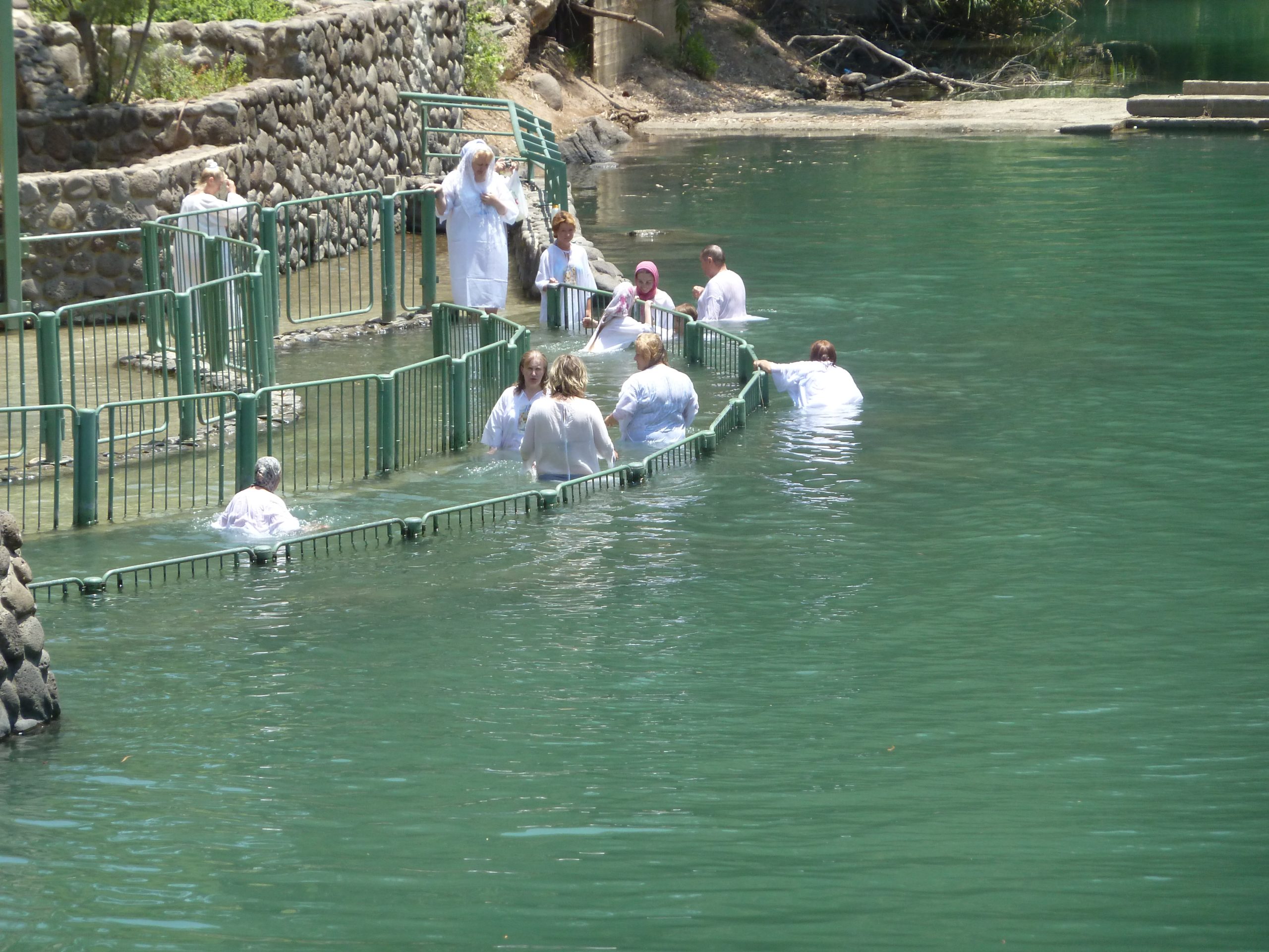 Pilgrims being baptized in the Jordan River at the Qasr al-Yahud baptism site