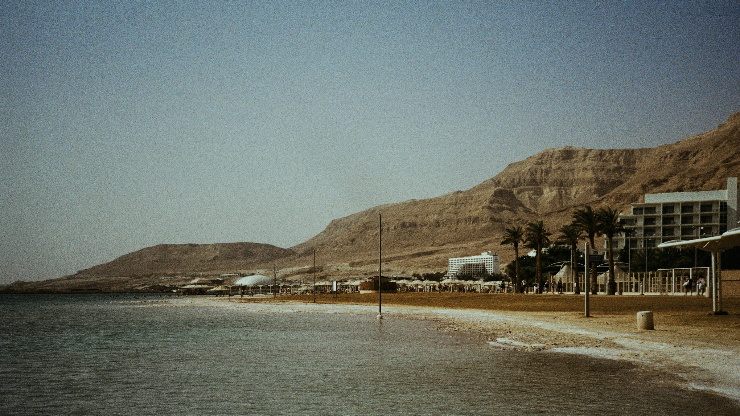 The Dead Sea shore below the desert mountains near Qumran in Israel
