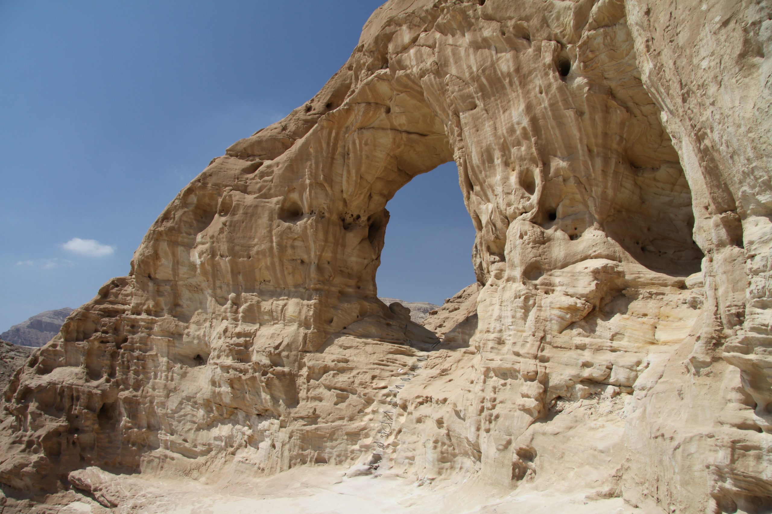 Natural rock arches in Timna Park against the desert sky