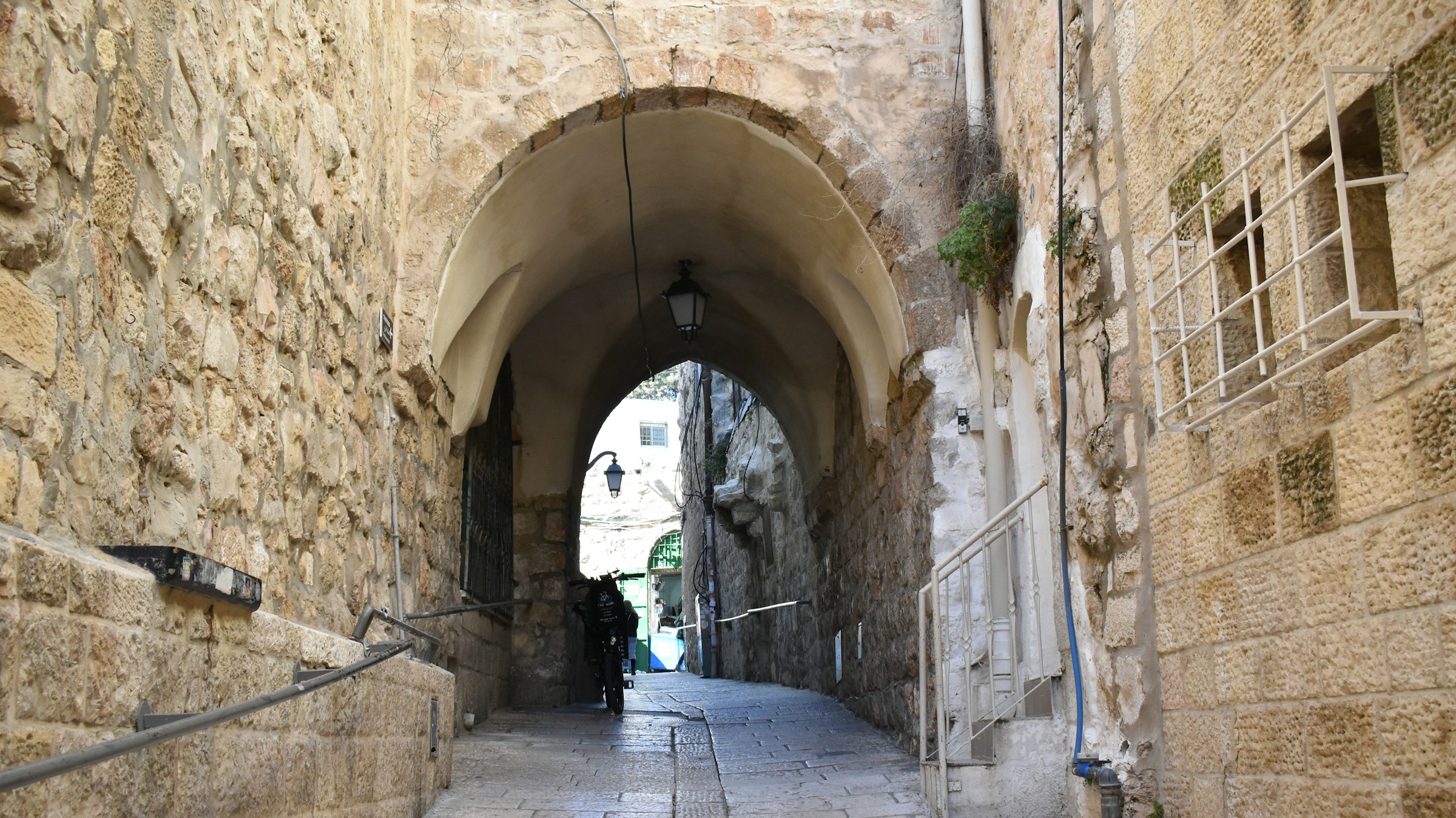 A narrow stone street on the Via Dolorosa in the Old City of Jerusalem