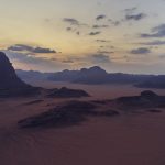Wadi Rum desert with red sand and towering sandstone mountains