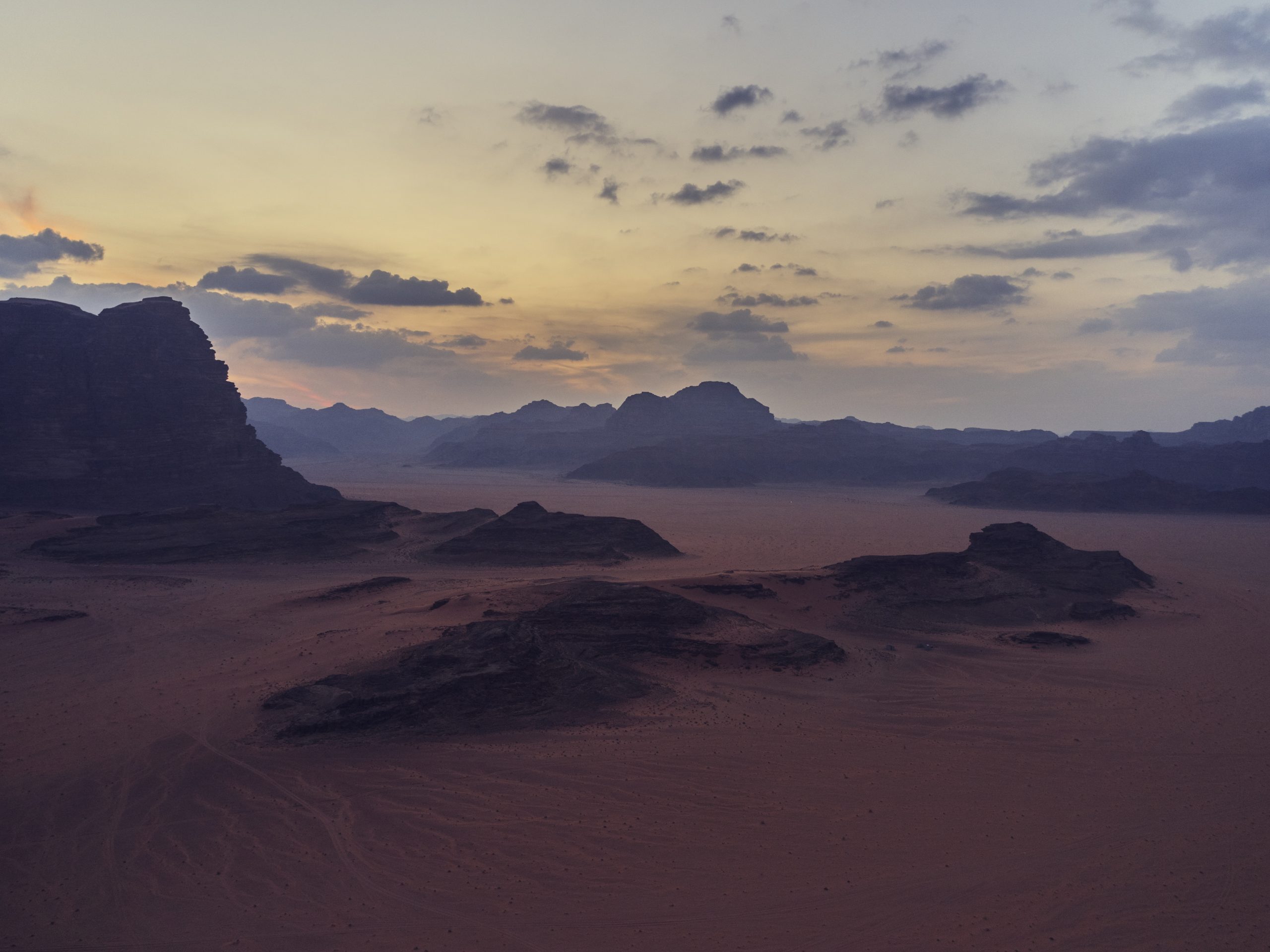 Wadi Rum desert with red sand and towering sandstone mountains