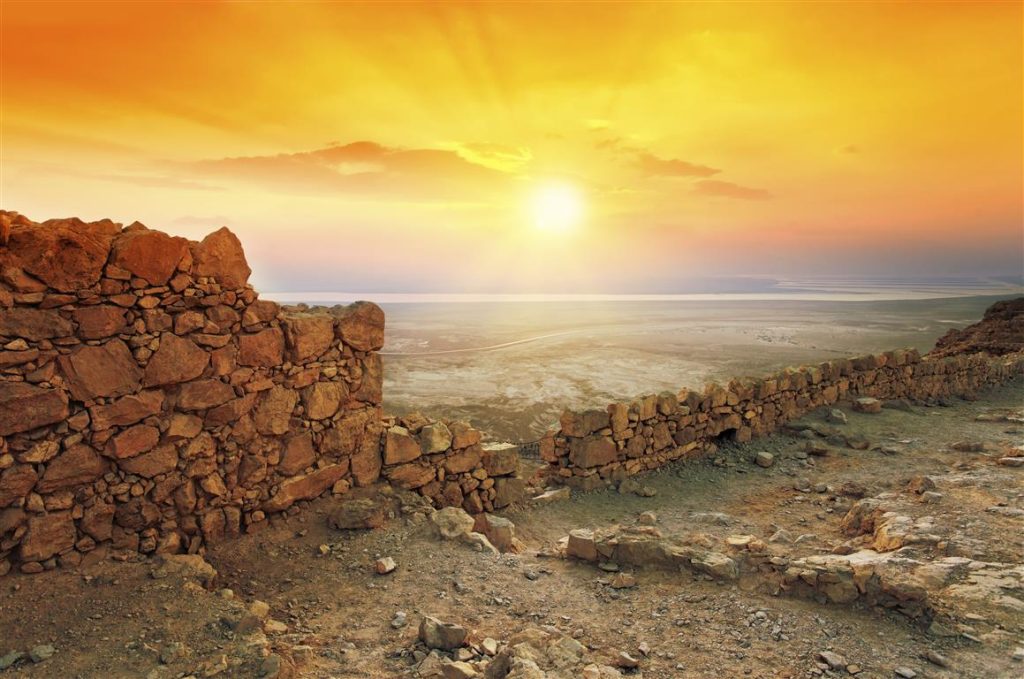 Sunrise over the ruins of Masada above the Dead Sea